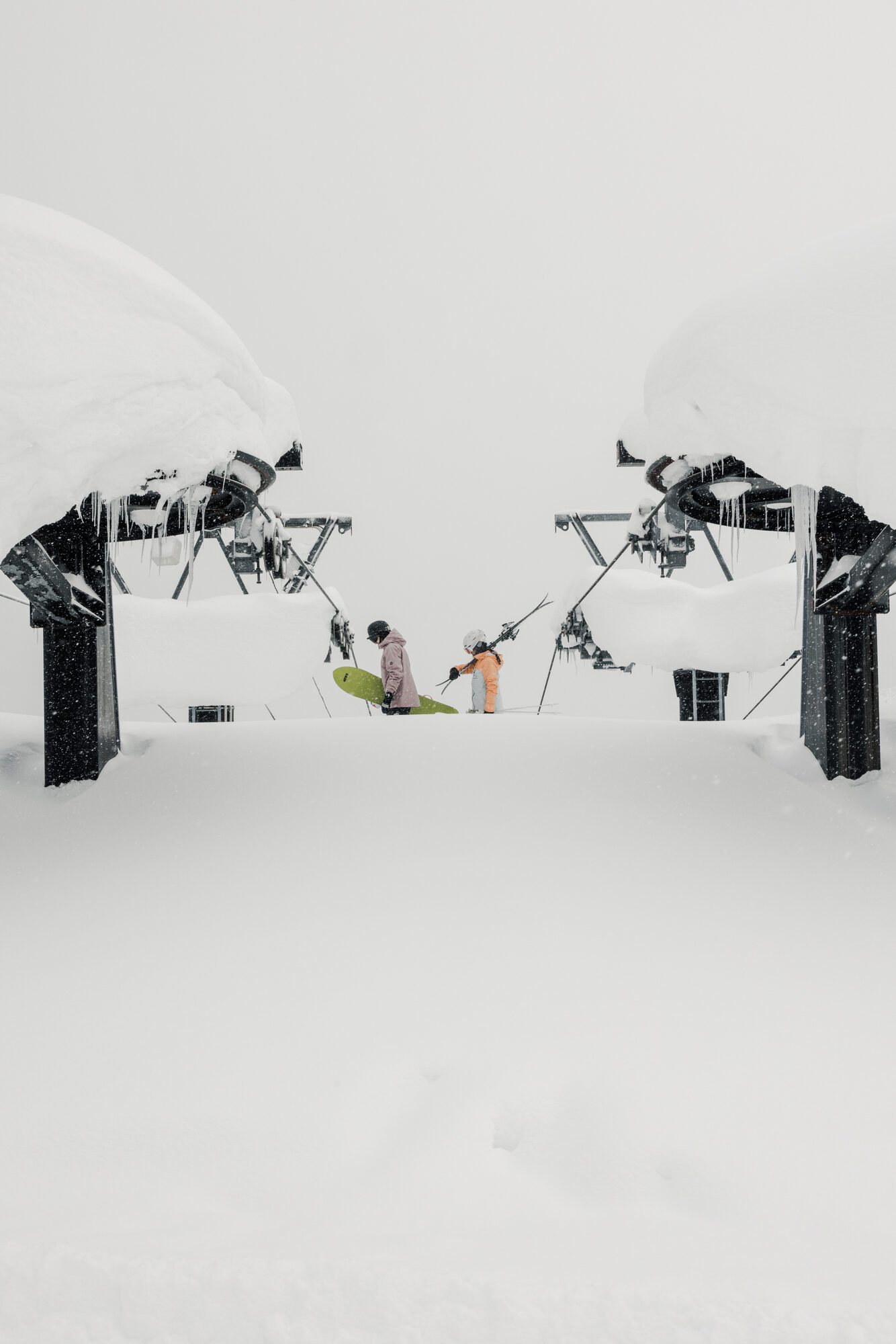 Skiers waiting at a buried chairlift