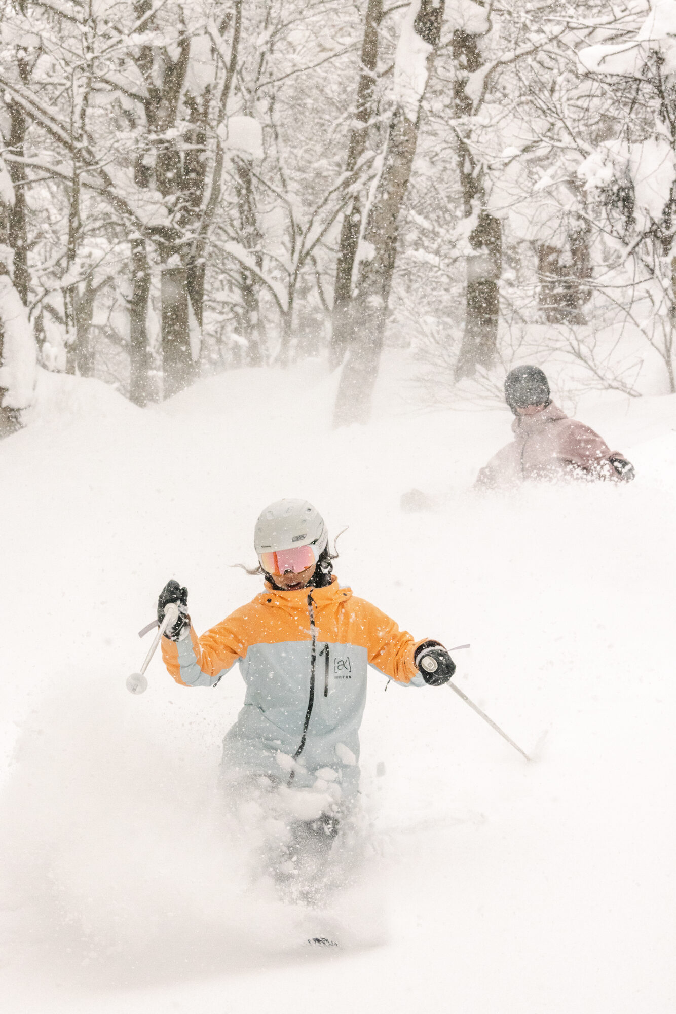 Skier charging deep Japanese powder